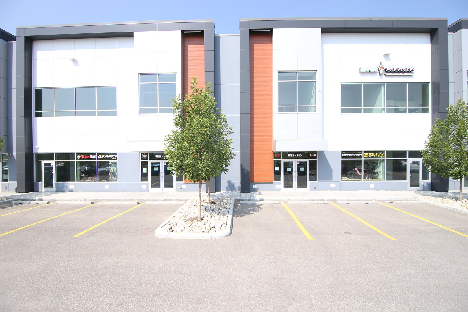 eBikes Calgary storefront — both retail units, viewed from 15th St NE